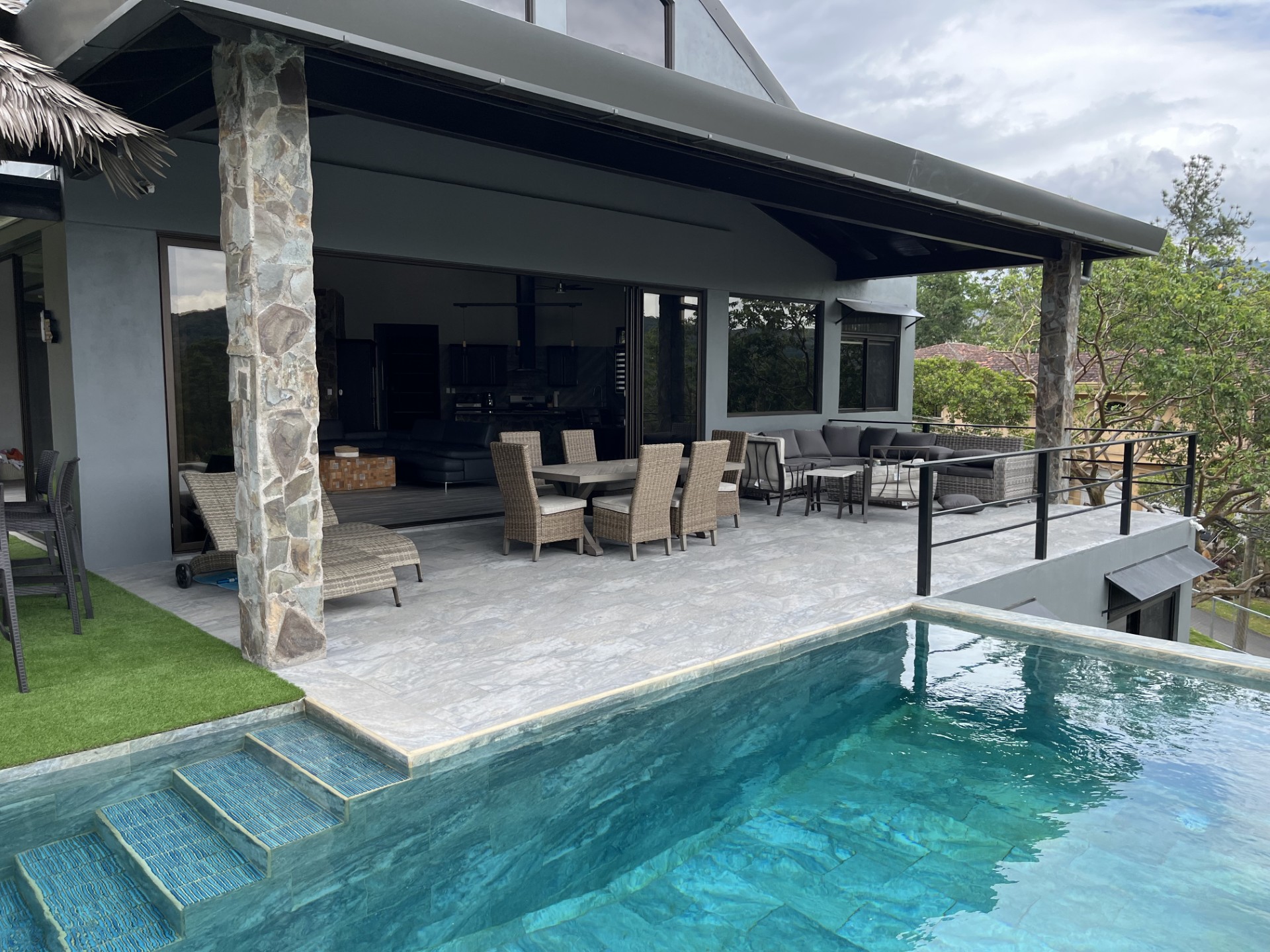 Outdoor rancho with grill, fridge, and seating overlooking golf course