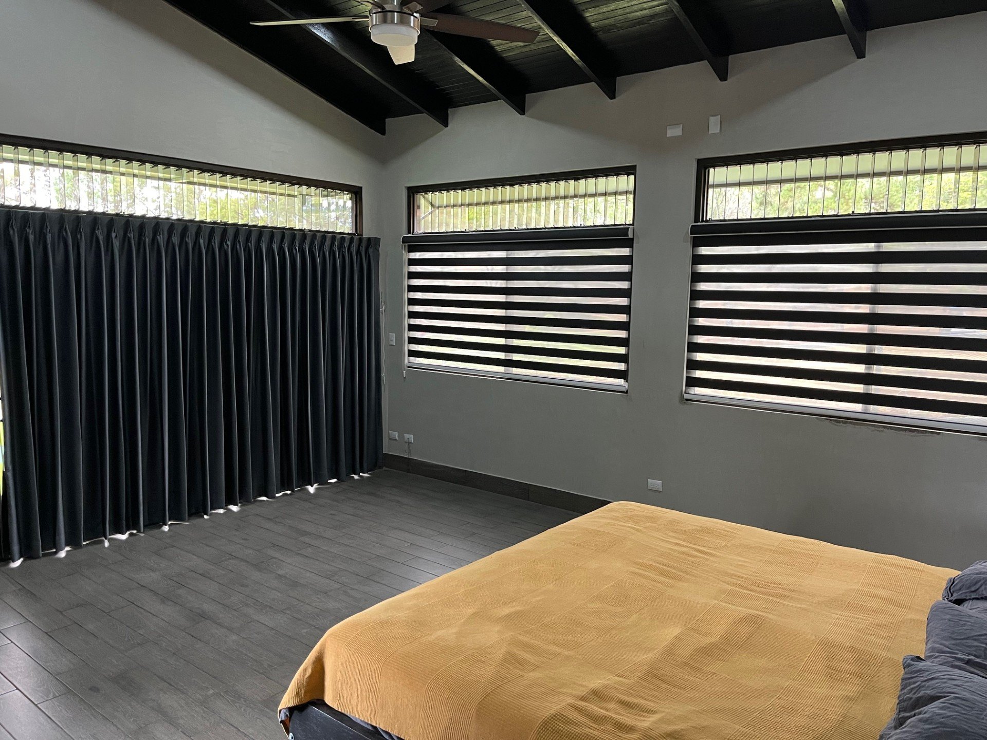 Master bedroom with king bed and large windows